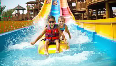 Family enjoying water slides at Aquaventure World Dubai Family enjoying water slides at Aquaventure World Dubai